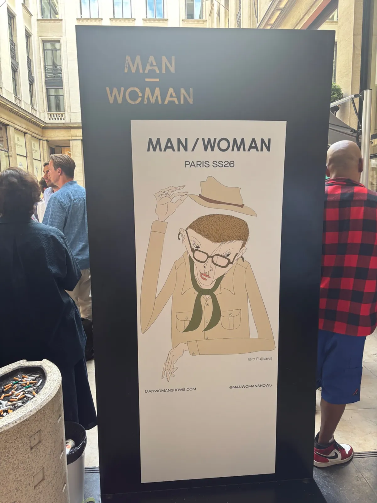 MAN/WOMAN Paris SS26 entrance signage on the street outside the show.